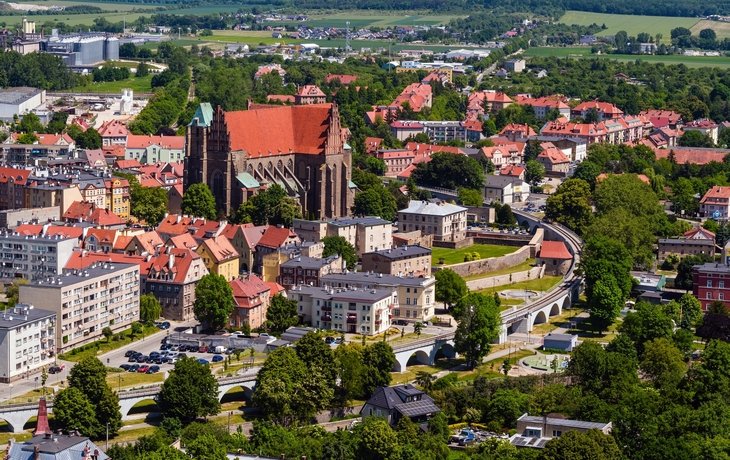Städtischer Platz mit historischen Gebäuden und Bäumen an einem sonnigen Tag. - © Marcin - stock.adobe.com